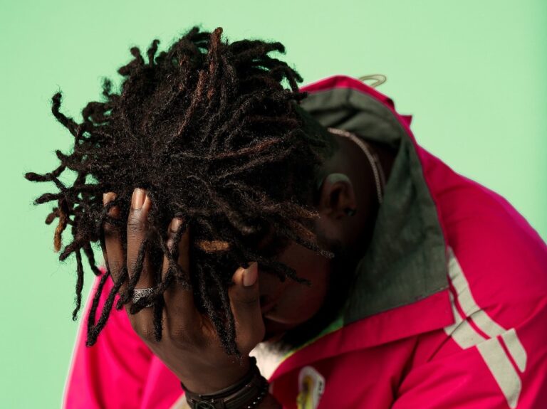 dreads in red jacket hand on hair2