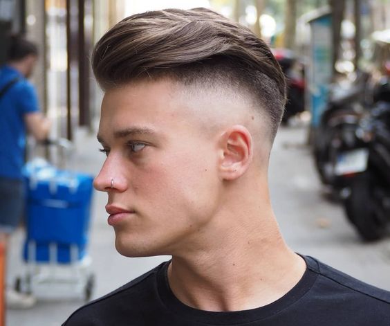 Man looking to left with classic undercut haircut