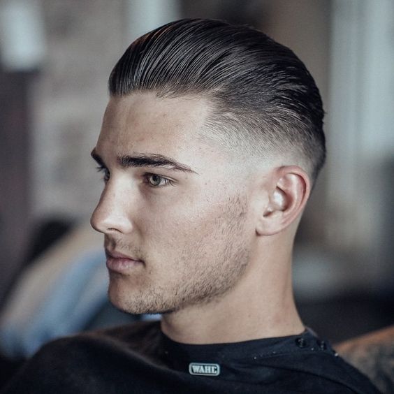man with a long slick back hairstyle