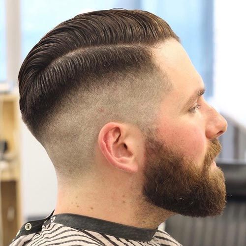 Man with a comb over skin fade haircut