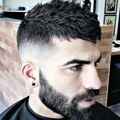 man looking to his right with a textured crop haircut